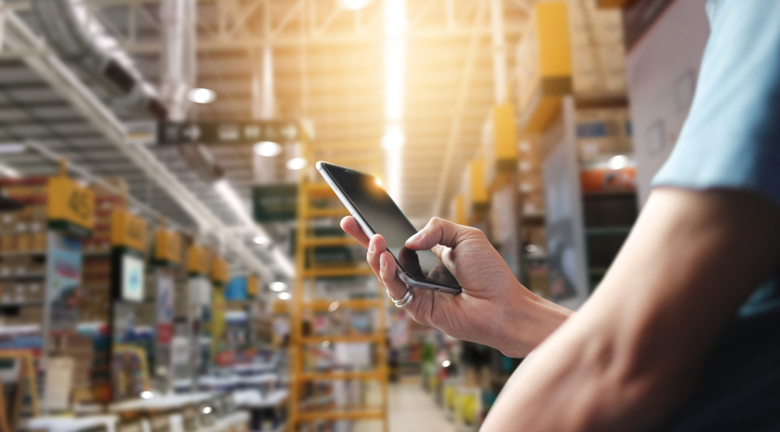 Factory worker using application on mobile smartphone to operrat
