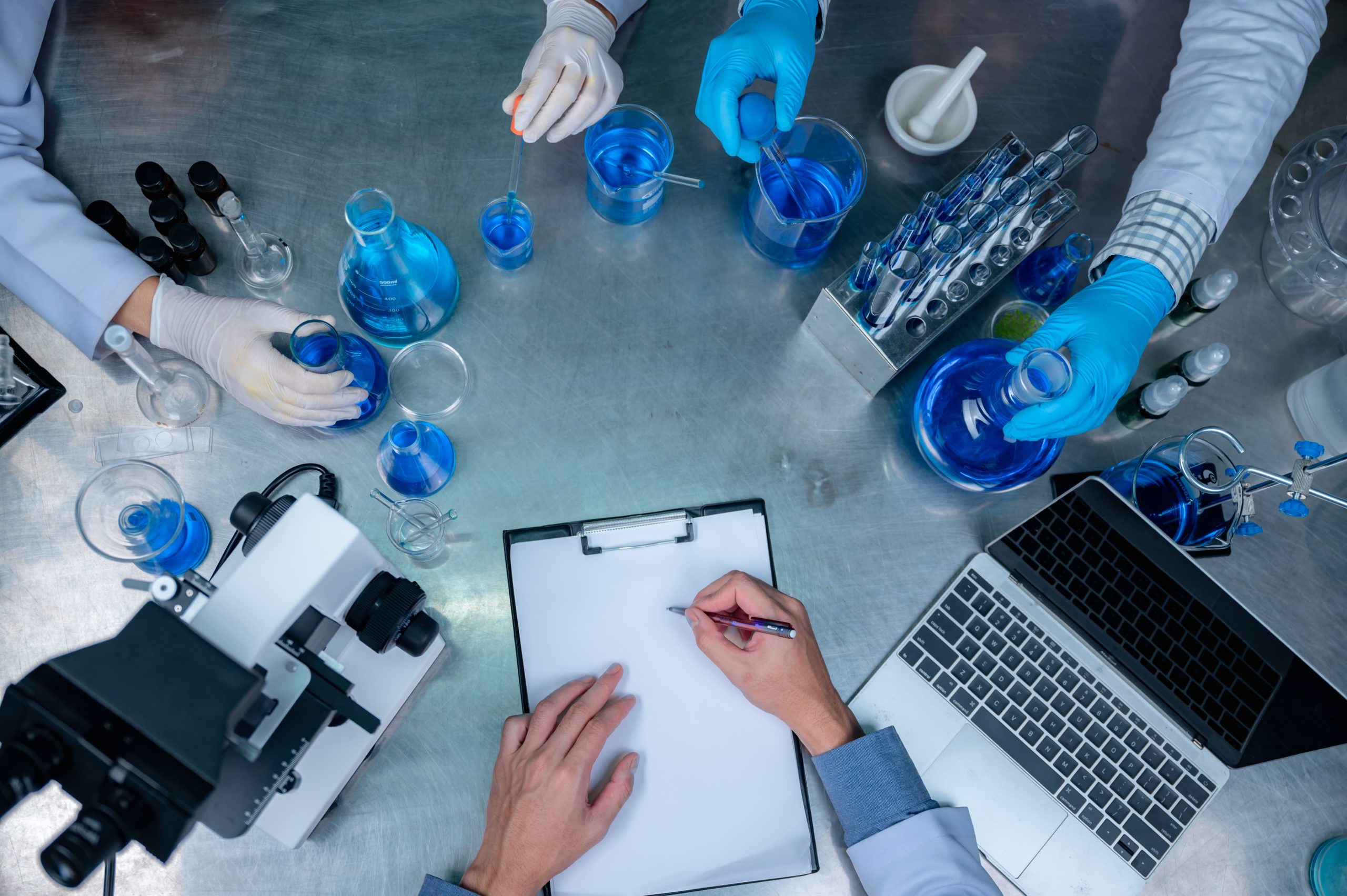 science-and-medicine-scientist-analyzing-and-dropping-sample-into-glassware-experiments-containing-chemical-liquid-in-laboratory-on-glassware-dna-structure-innovative-and-technology-min